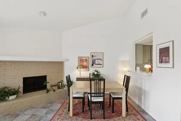 a view of a dining room with furniture and a fireplace
