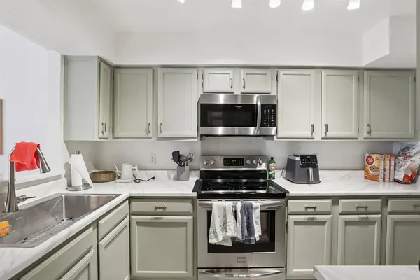 a kitchen with a sink and a stove top oven