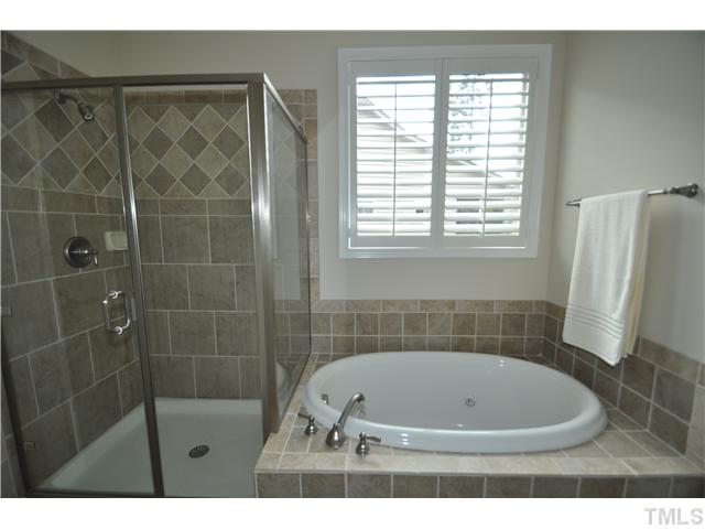 6217 Oconner Street Raleigh, NC 27617 - Photo 14 of 17 a bathroom with a bathtub and a shower