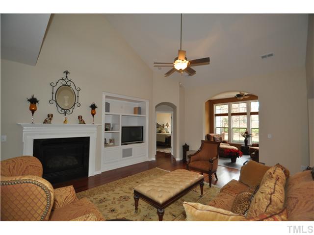 6217 Oconner Street Raleigh, NC 27617 - Photo 3 of 17 a living room with furniture a fireplace and a flat screen tv