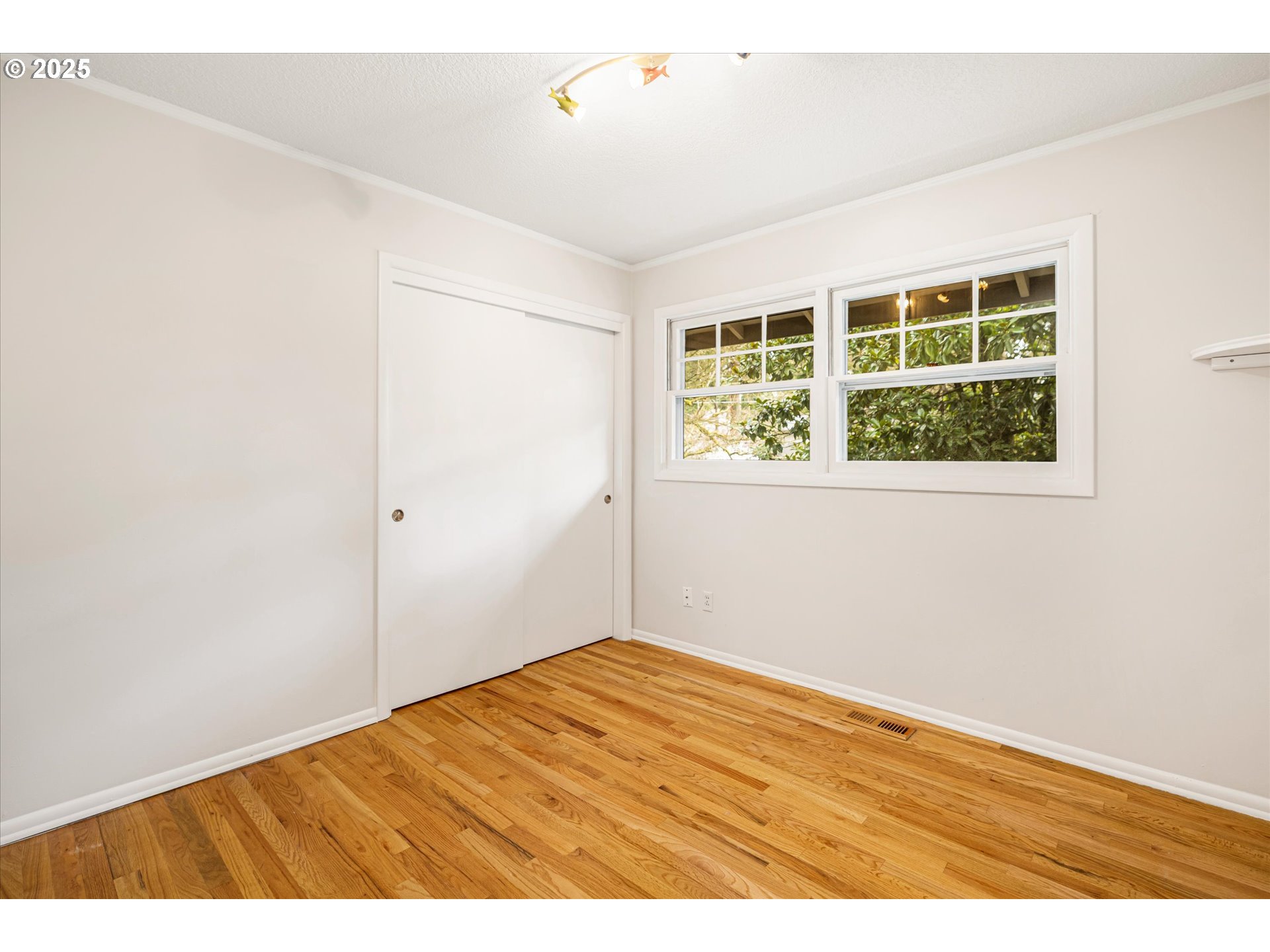 764 10th Street Lake Oswego, OR 97034 - Photo 24 of 41 an empty room with wooden floor and windows