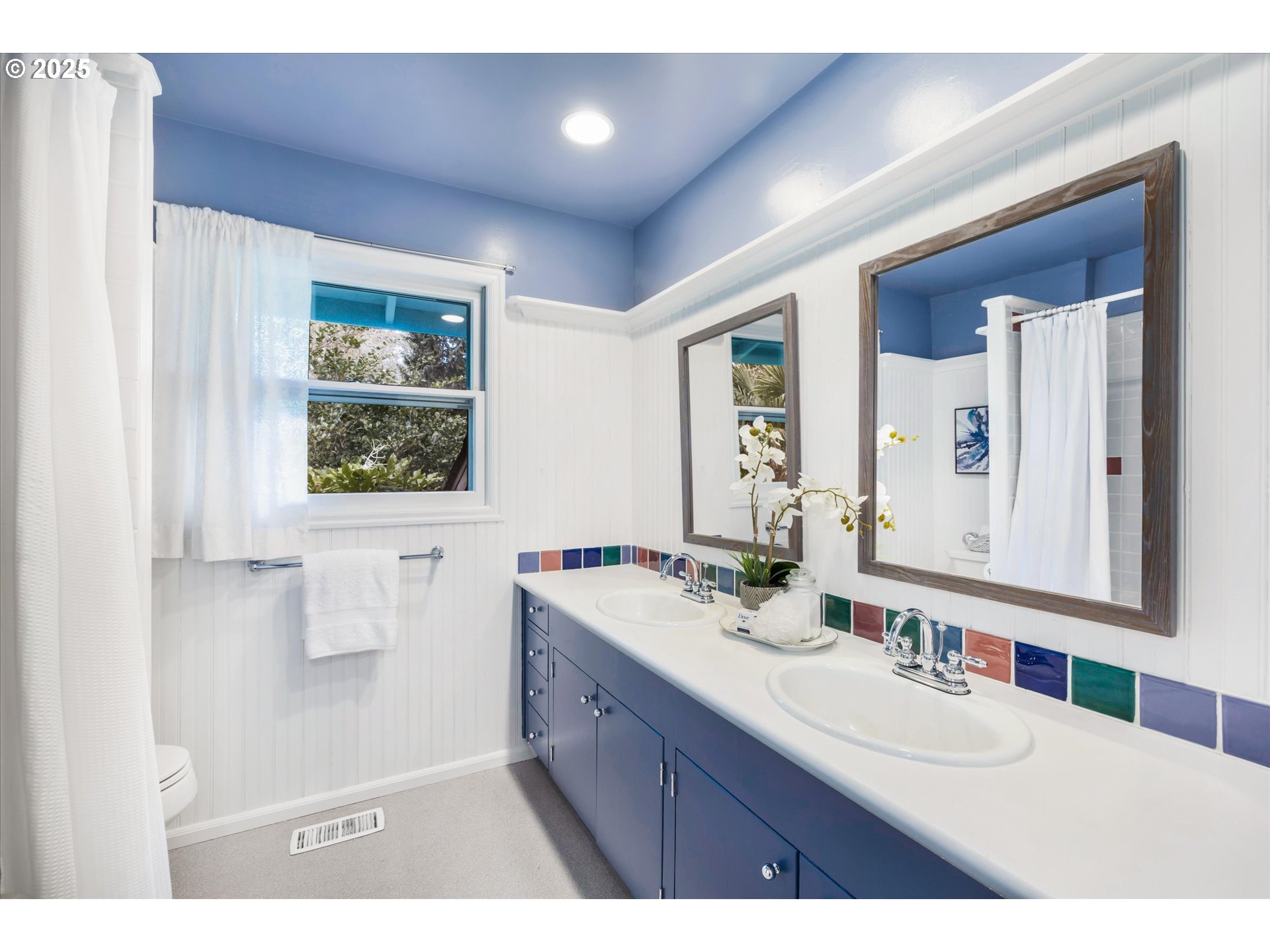 764 10th Street Lake Oswego, OR 97034 - Photo 25 of 41 a bathroom with a sink a mirror and a window