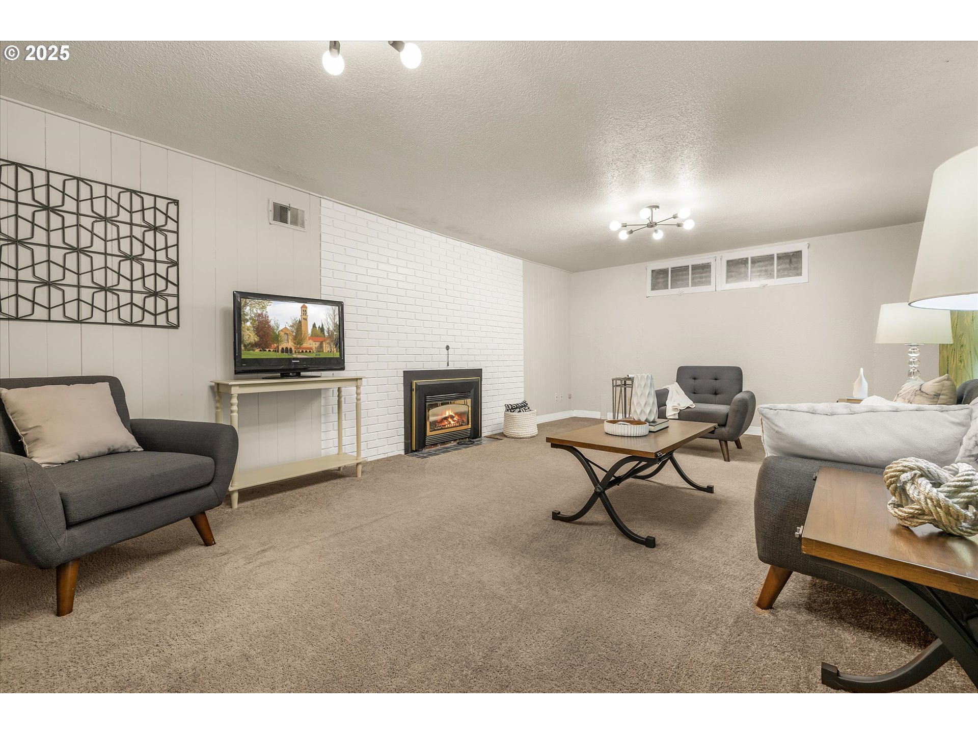 764 10th Street Lake Oswego, OR 97034 - Photo 34 of 41 a living room with furniture a fireplace and a flat screen tv