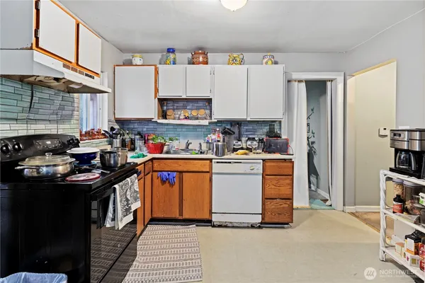 a kitchen with stainless steel appliances and white cabinets