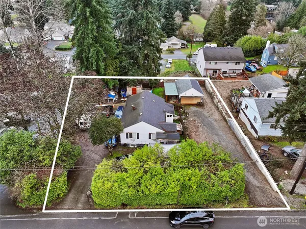 an aerial view of a house with a yard basket ball court