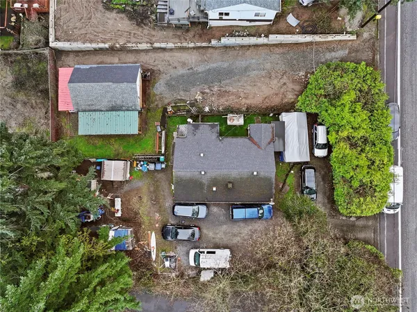 an aerial view of a house with a yard and a wooden deck