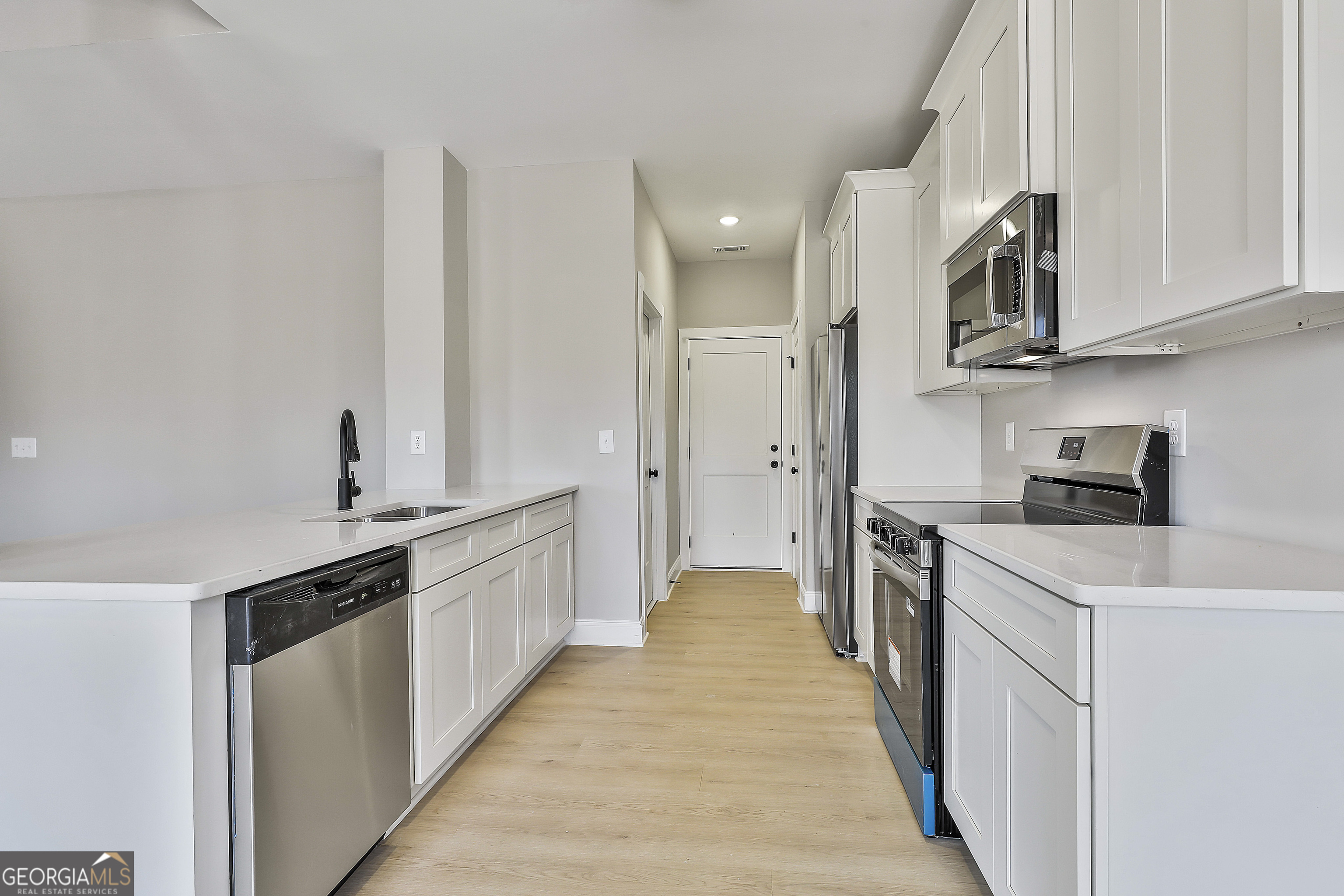 35 Oak Road Locust Grove, GA 30248 - Photo 14 of 36 a kitchen with stainless steel appliances a sink stove and refrigerator