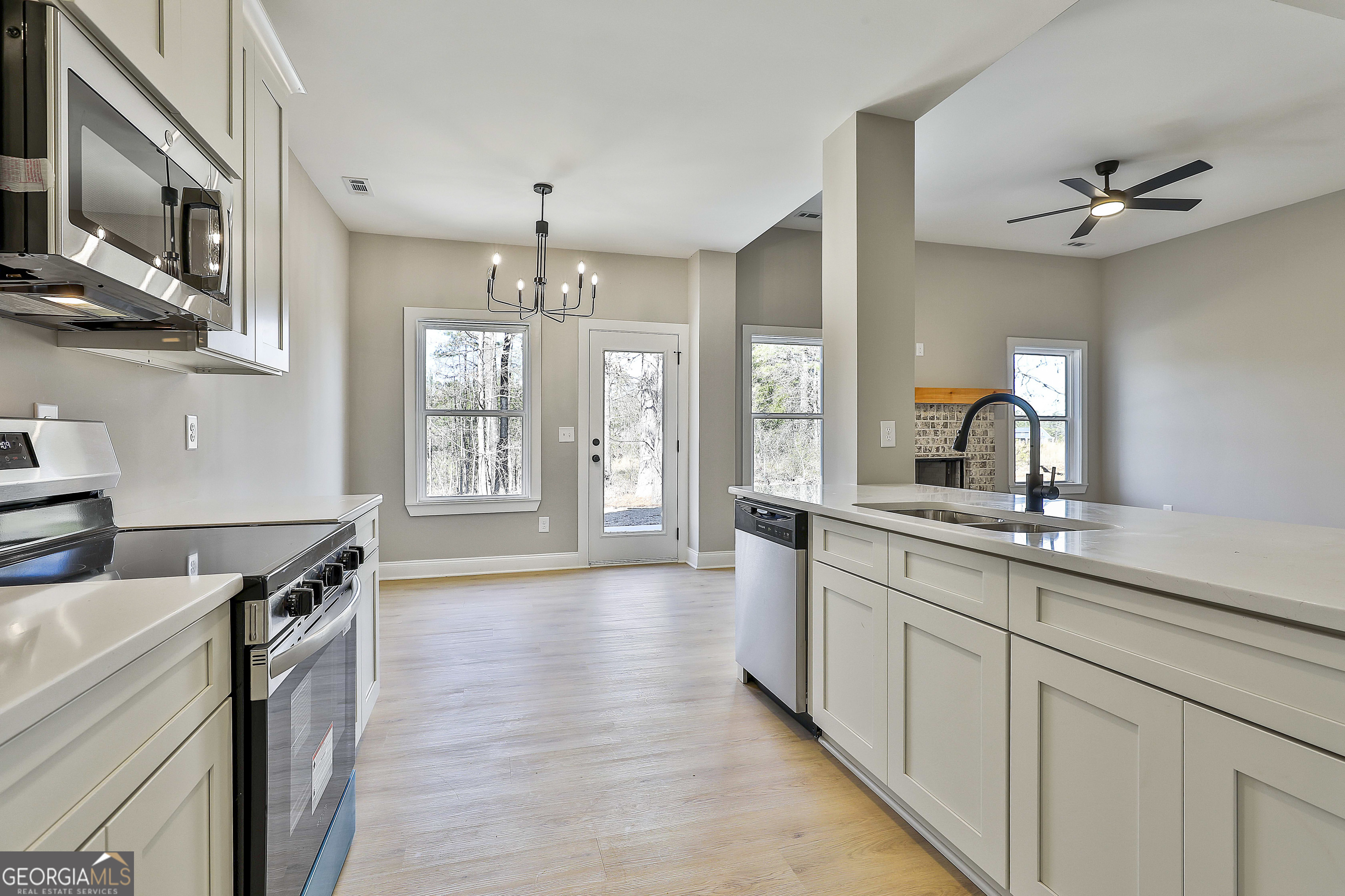 35 Oak Road Locust Grove, GA 30248 - Photo 16 of 36 a kitchen with stainless steel appliances a sink stove and cabinets