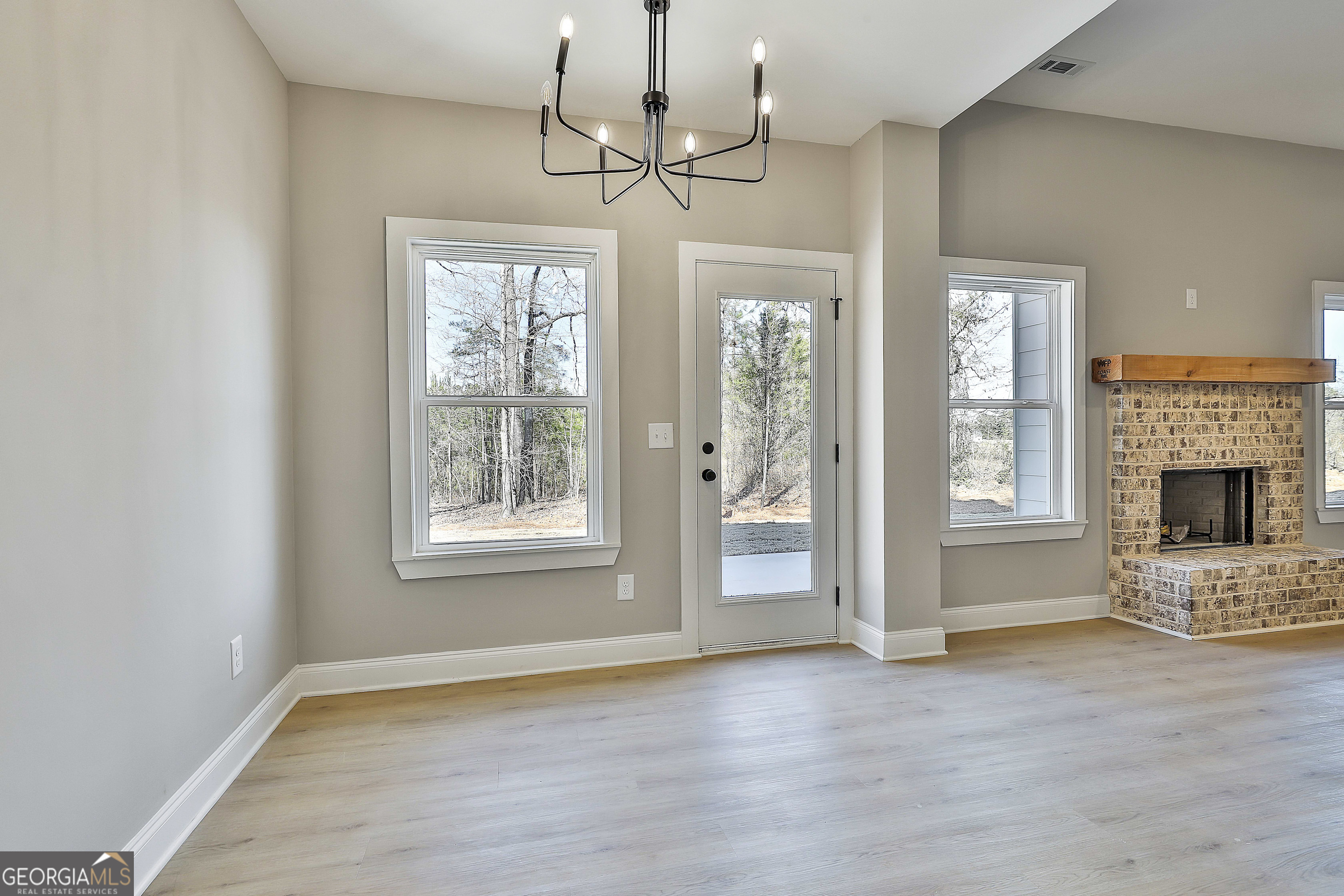35 Oak Road Locust Grove, GA 30248 - Photo 17 of 36 a view of livingroom with window fireplace and wooden floor
