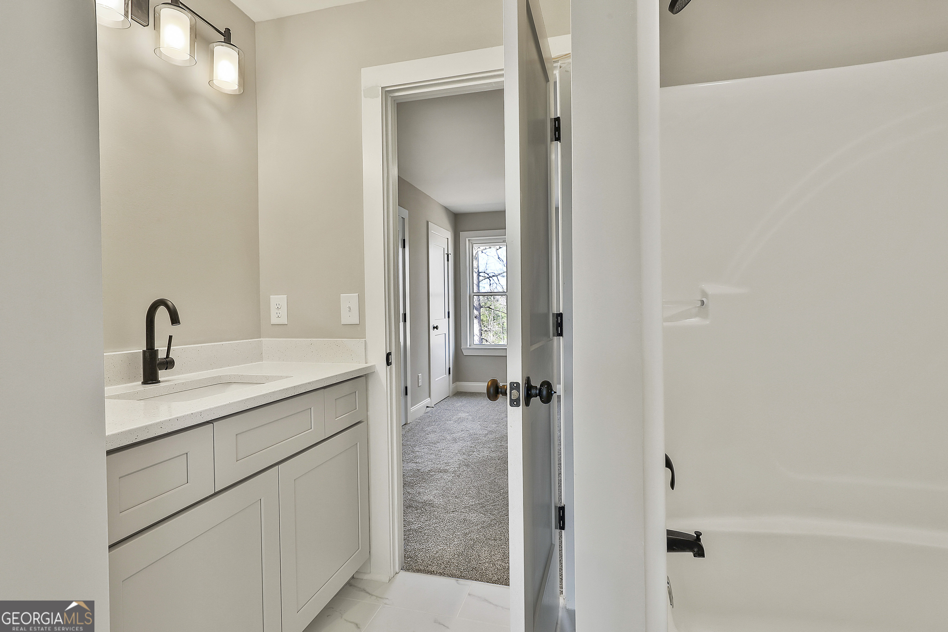 35 Oak Road Locust Grove, GA 30248 - Photo 28 of 36 a bathroom with a granite countertop sink a mirror and a shower