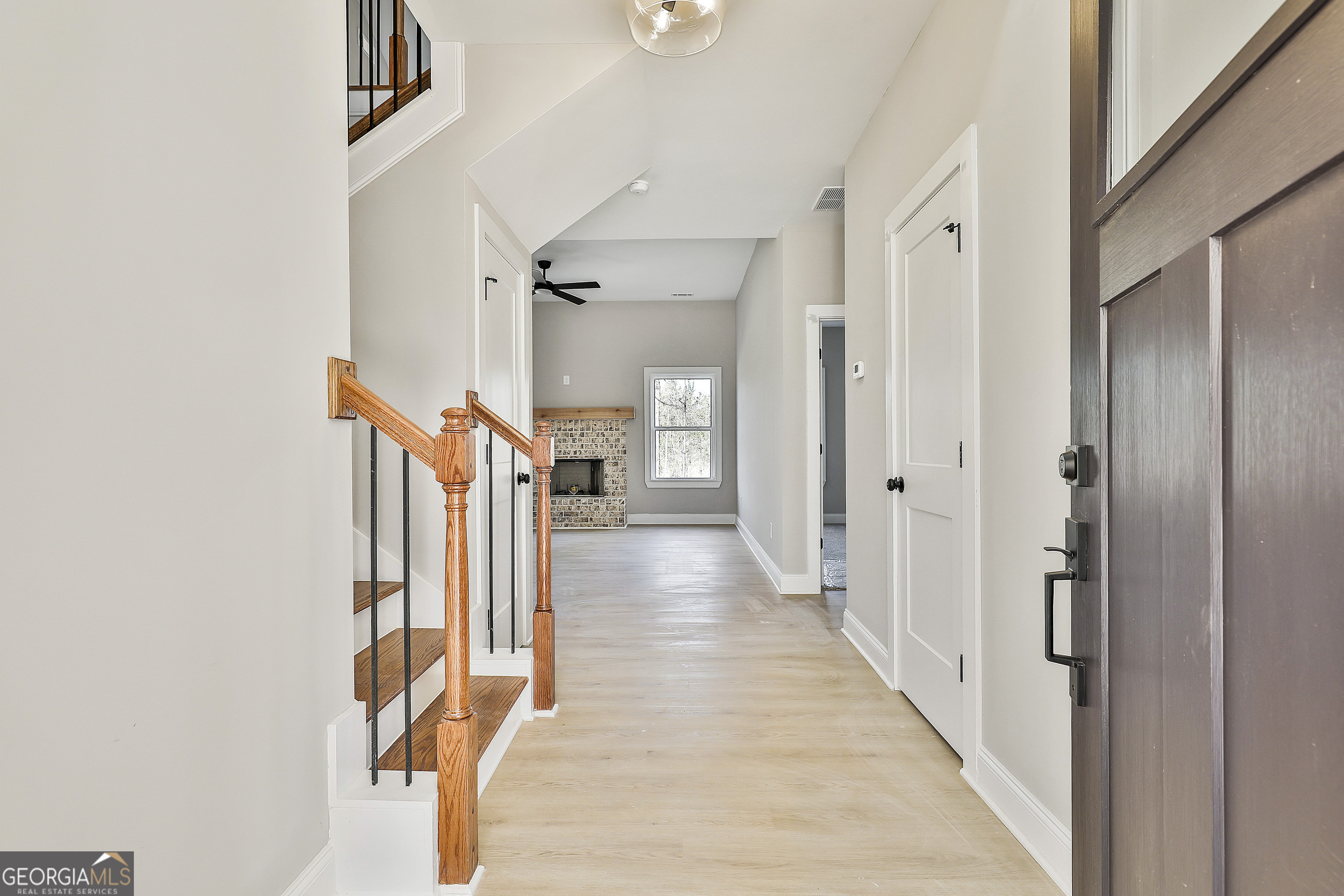 35 Oak Road Locust Grove, GA 30248 - Photo 6 of 36 a view of a hallway with wooden floor and staircase