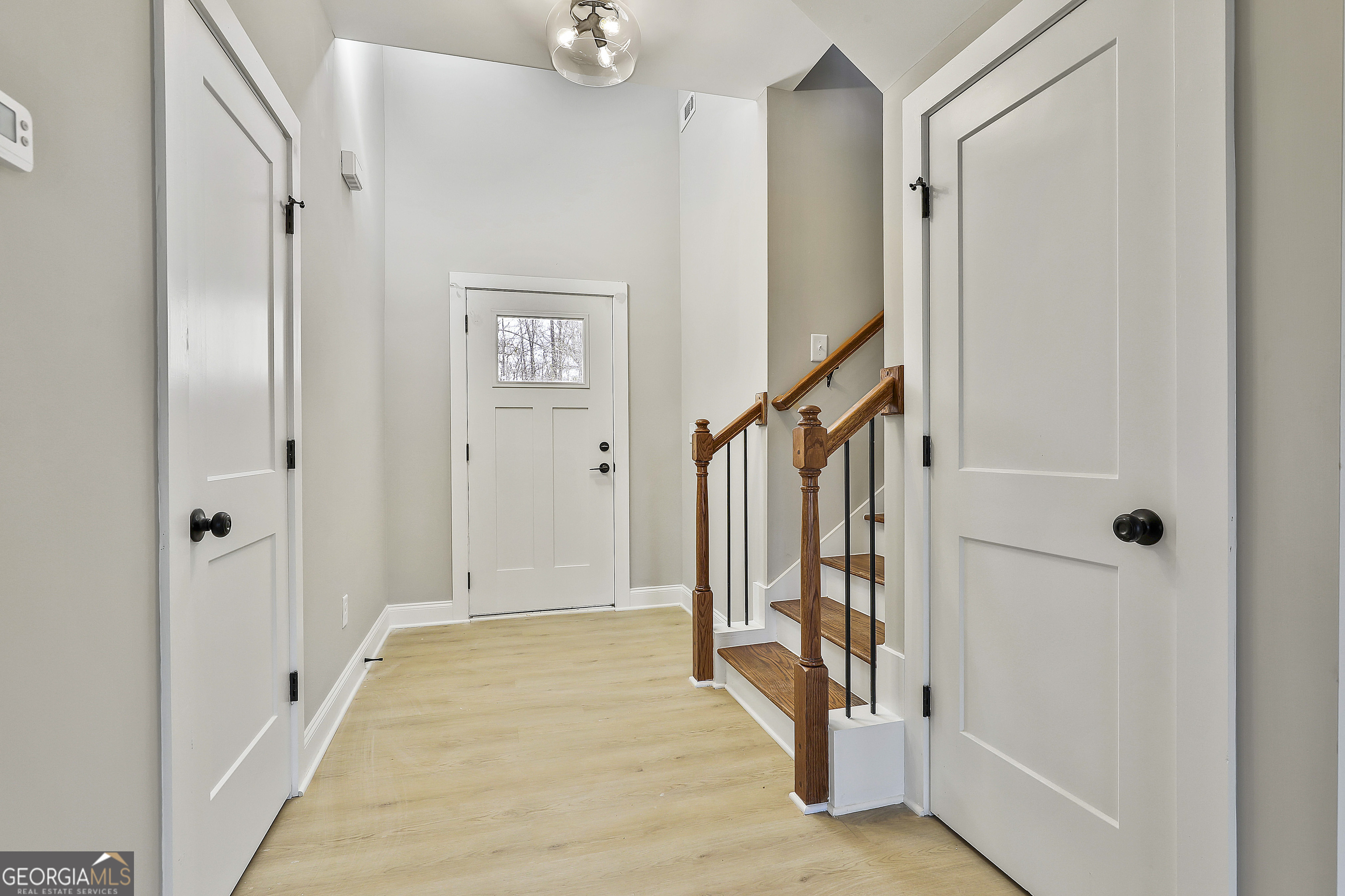 35 Oak Road Locust Grove, GA 30248 - Photo 7 of 36 a view of a hallway with wooden floor and entryway