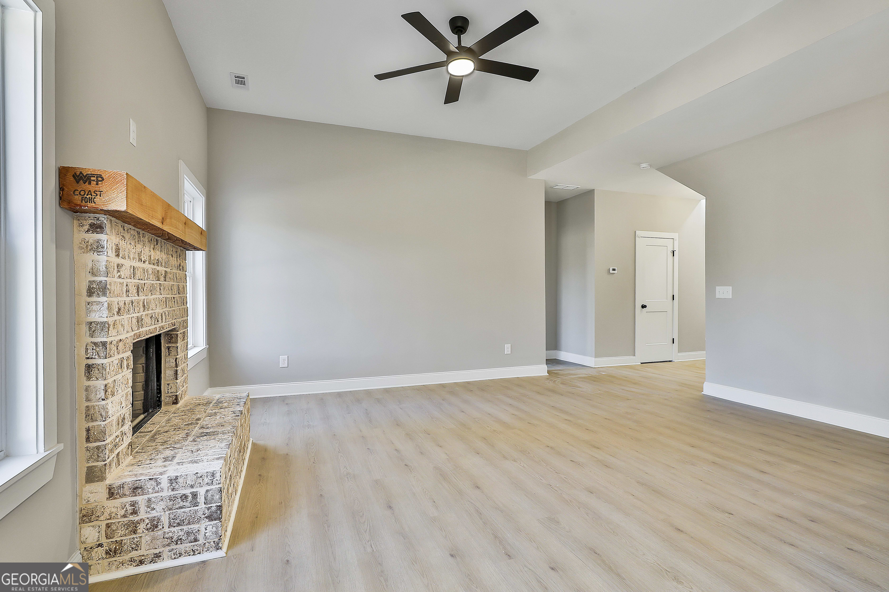 35 Oak Road Locust Grove, GA 30248 - Photo 10 of 36 a view of an empty room with a fireplace and a window