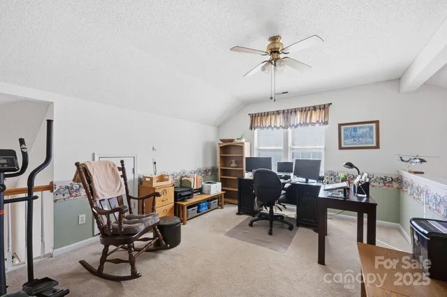 a view of a livingroom with furniture window and a ceiling fan
