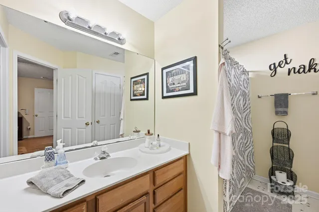 a bathroom with a sink vanity and mirror
