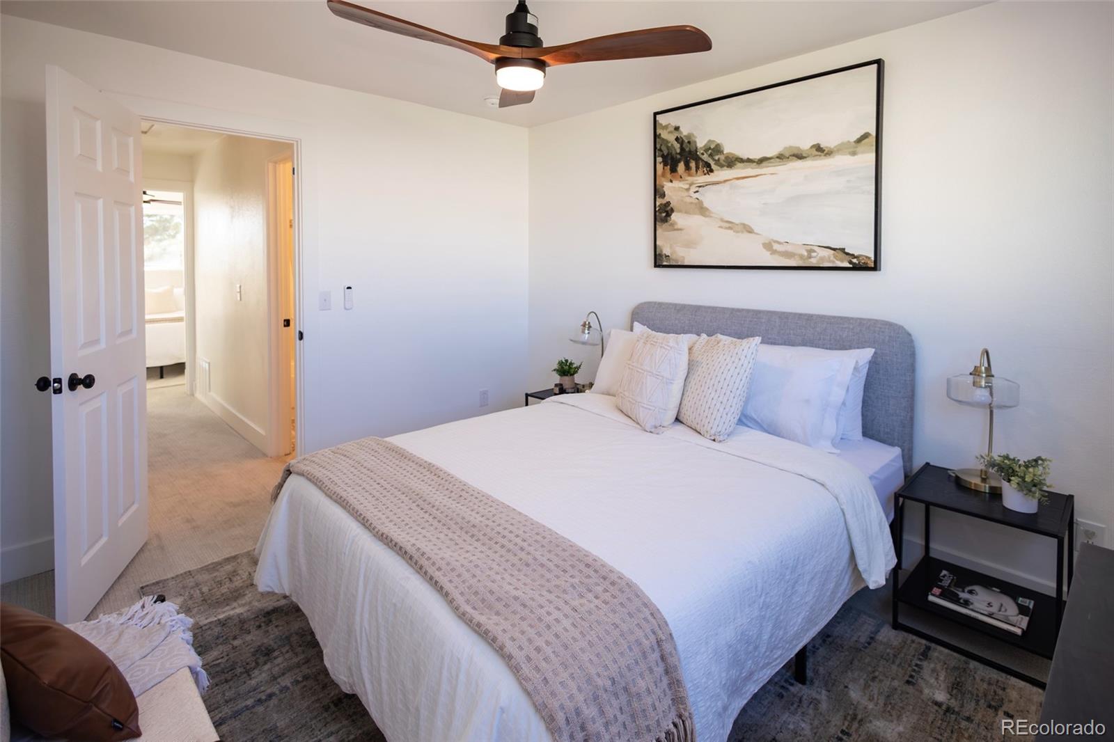 5711 West 92nd Avenue, Unit 20 Westminster, CO 80031 - Photo 12 of 26 a bedroom with a bed and a painting on the wall