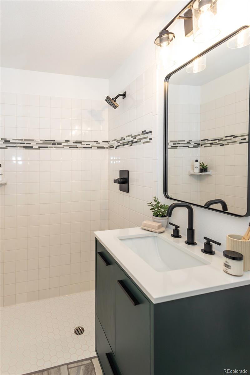 5711 West 92nd Avenue, Unit 20 Westminster, CO 80031 - Photo 13 of 26 a bathroom with a sink and a mirror