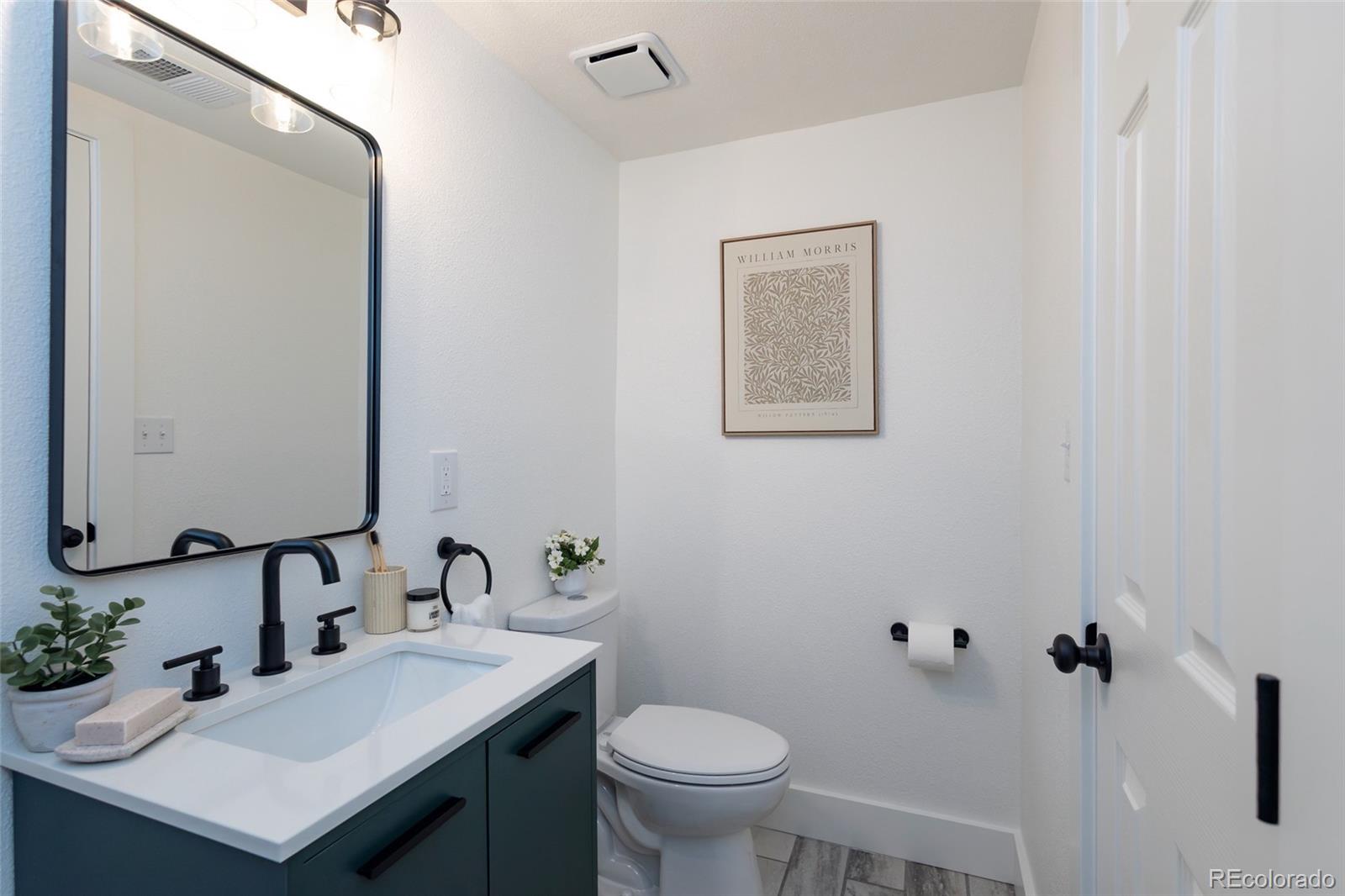 5711 West 92nd Avenue, Unit 20 Westminster, CO 80031 - Photo 14 of 26 a bathroom with a sink toilet and a mirror