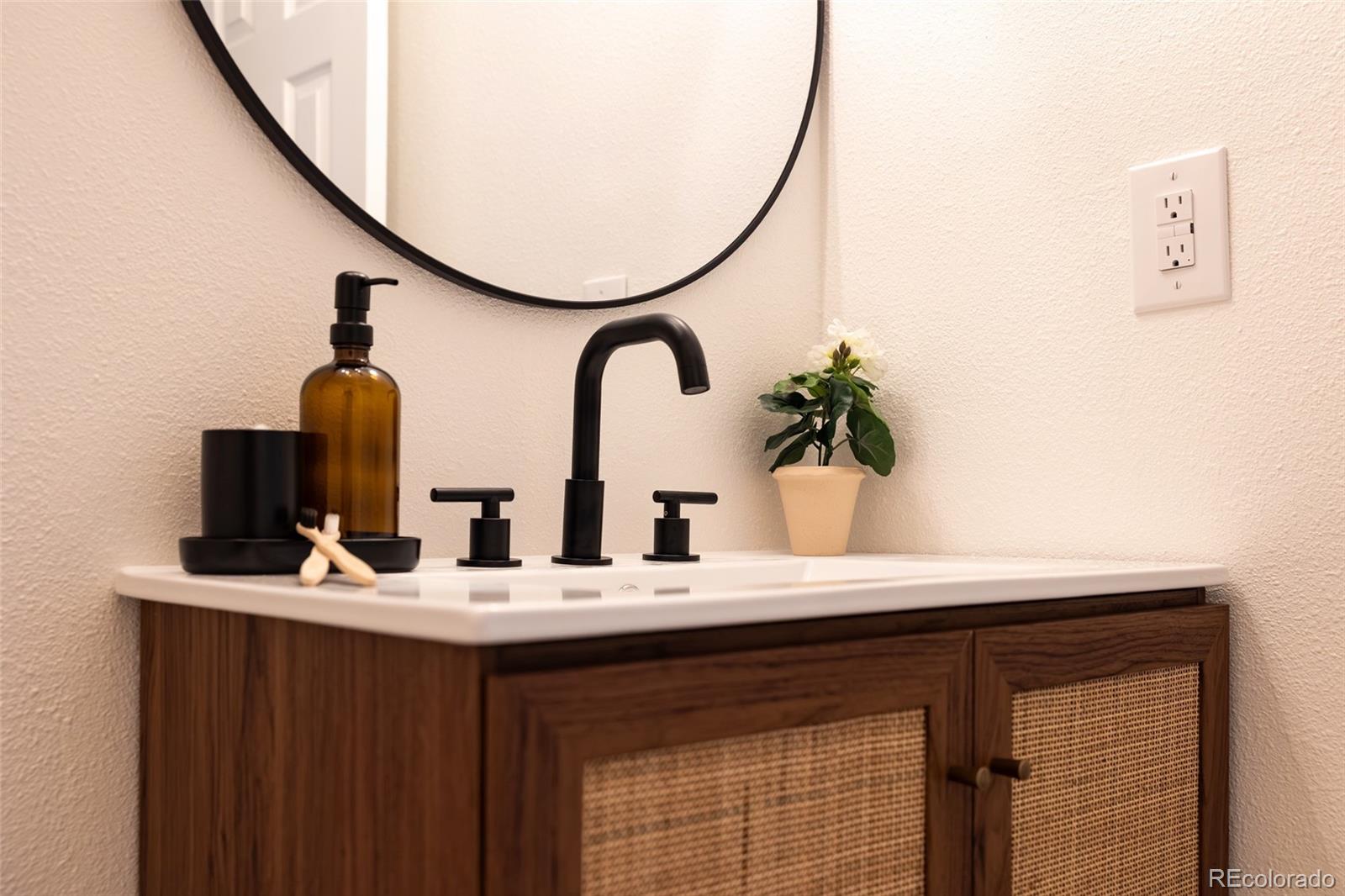 5711 West 92nd Avenue, Unit 20 Westminster, CO 80031 - Photo 16 of 26 a bathroom with a sink and a mirror