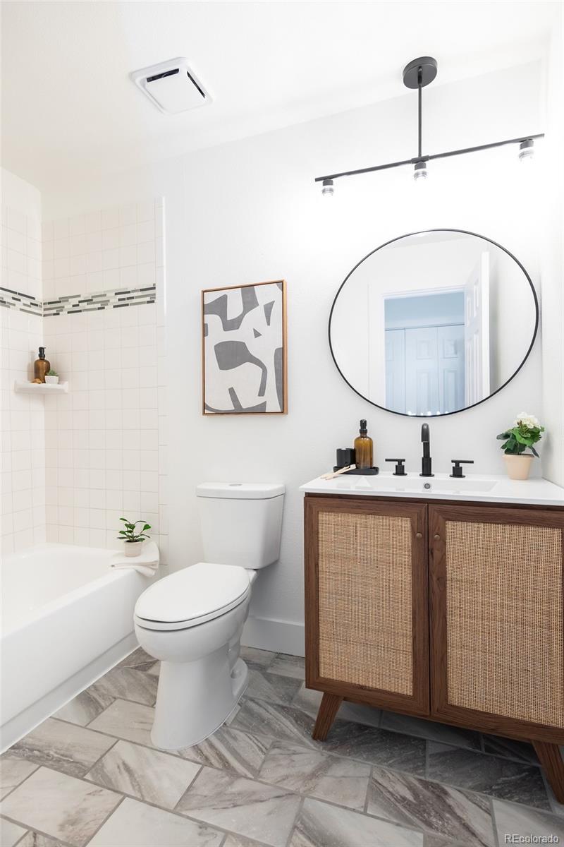 5711 West 92nd Avenue, Unit 20 Westminster, CO 80031 - Photo 17 of 26 a bathroom with a toilet a sink and mirror
