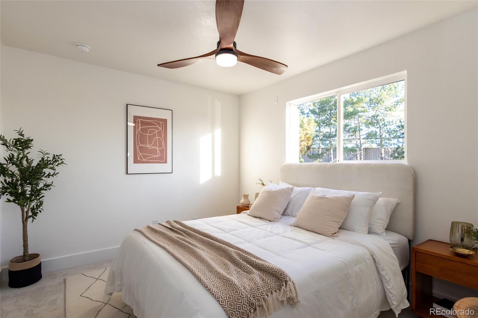 5711 West 92nd Avenue, Unit 20 Westminster, CO 80031 - Photo 18 of 26 a bedroom with a bed and a potted plant