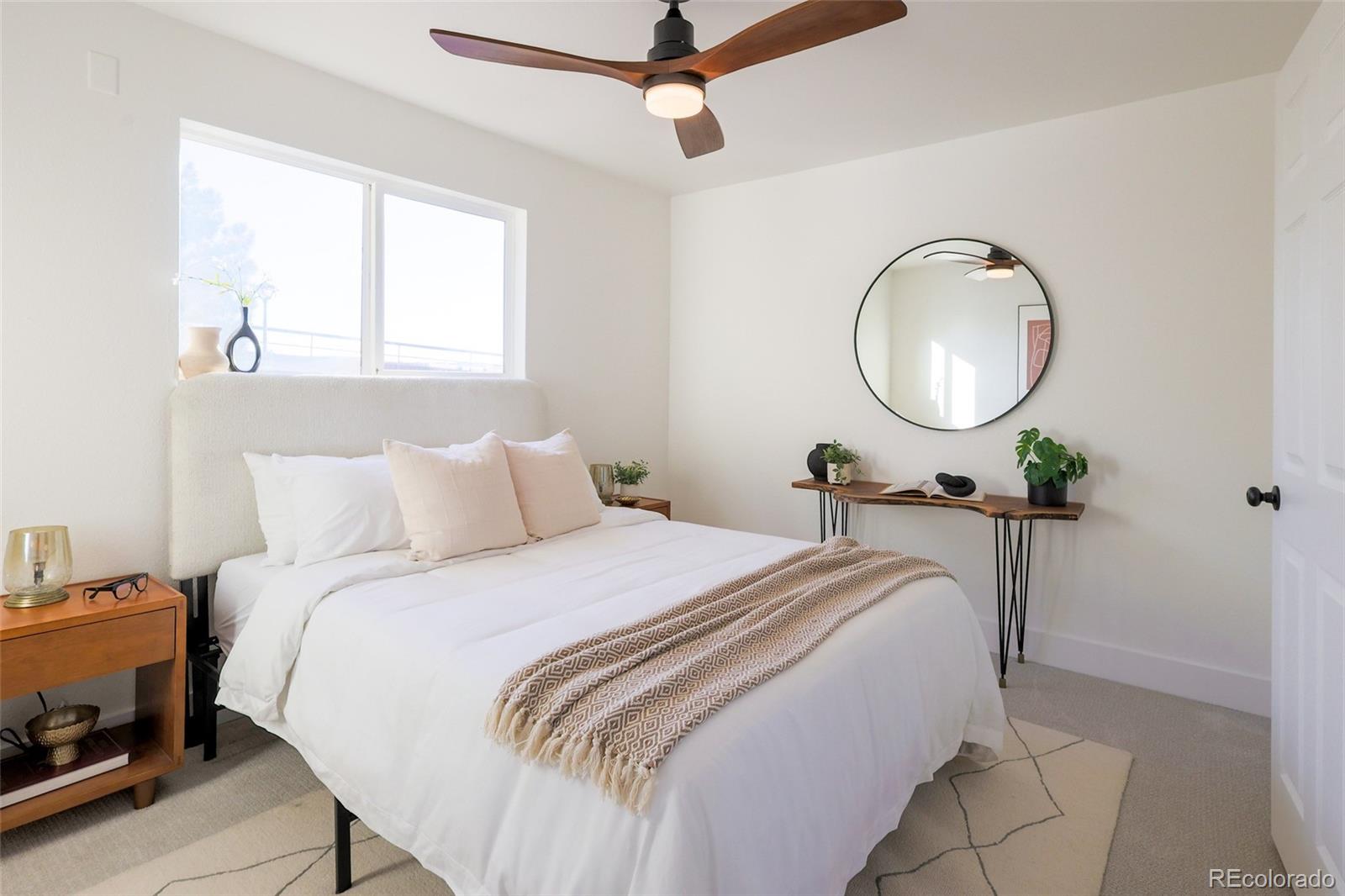 5711 West 92nd Avenue, Unit 20 Westminster, CO 80031 - Photo 19 of 26 a bed room with a bed and a chandelier