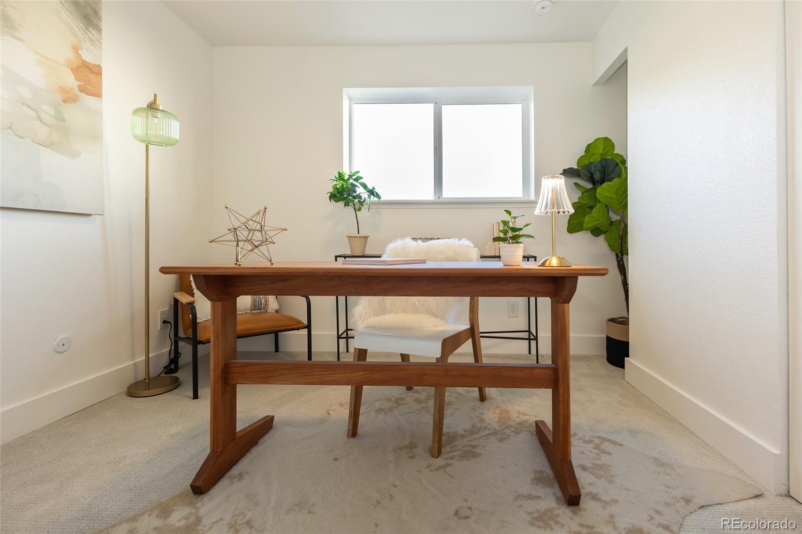 5711 West 92nd Avenue, Unit 20 Westminster, CO 80031 - Photo 20 of 26 a view of a room with a table and chairs