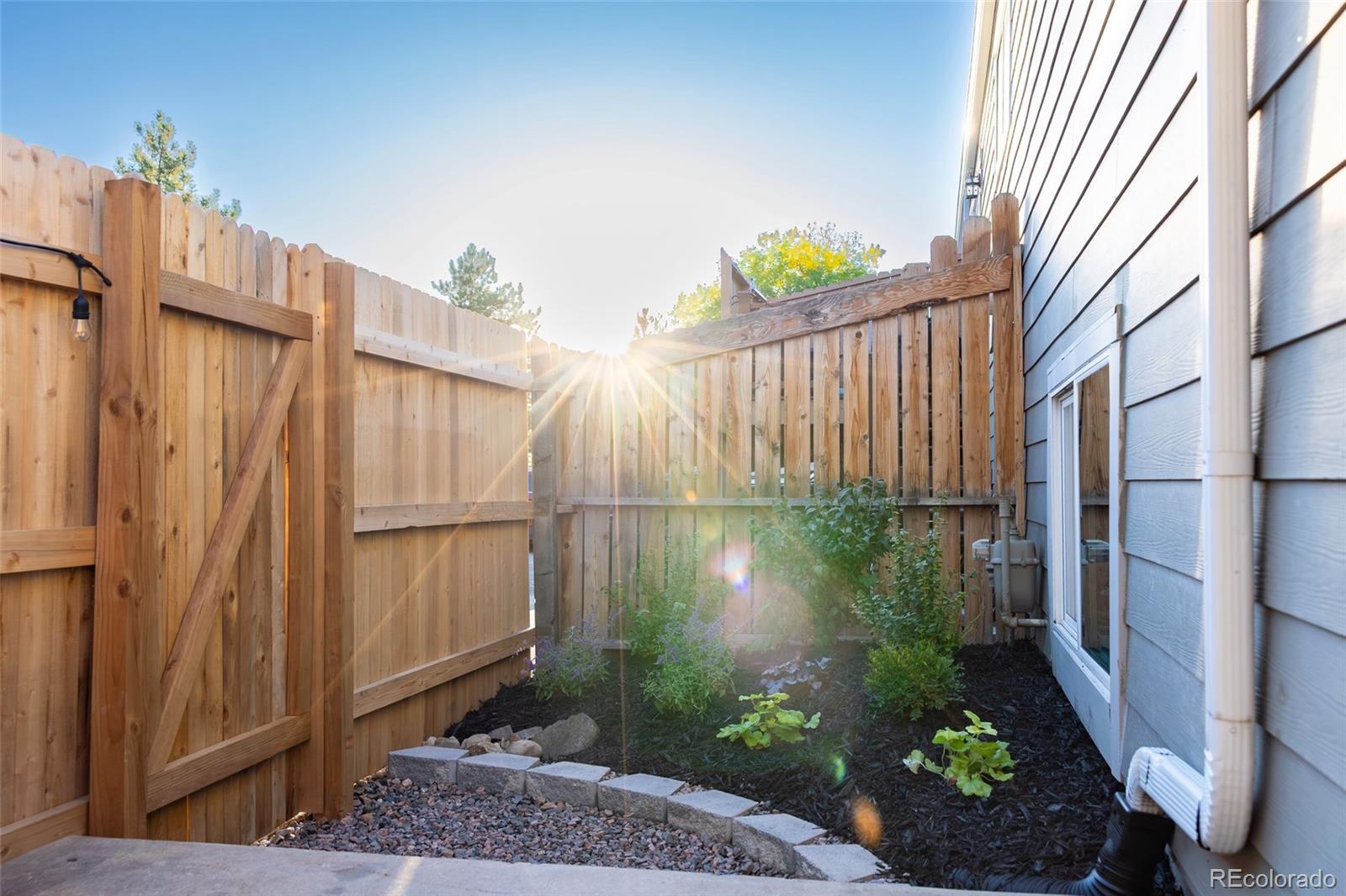5711 West 92nd Avenue, Unit 20 Westminster, CO 80031 - Photo 22 of 26 a backyard of a house with plants