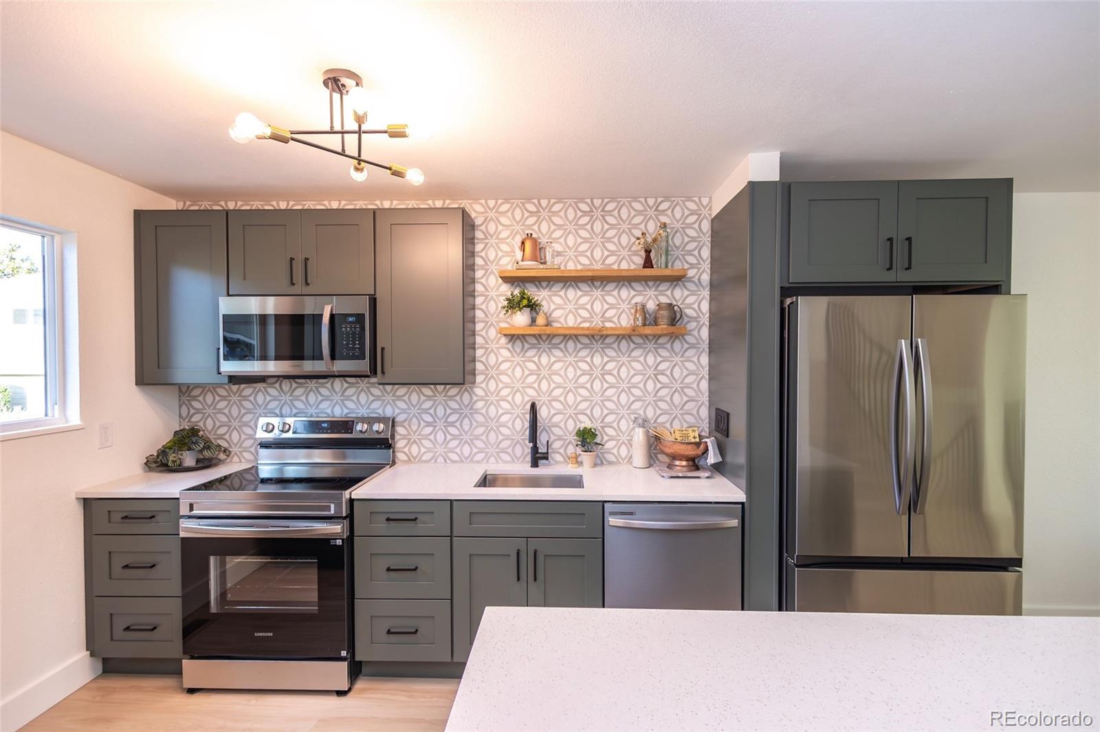 5711 West 92nd Avenue, Unit 20 Westminster, CO 80031 - Photo 6 of 26 a kitchen with a sink stove and refrigerator