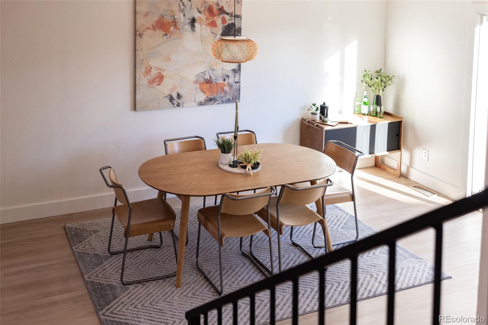 5711 West 92nd Avenue, Unit 20 Westminster, CO 80031 - Photo 10 of 26 a view of a dining room with furniture and wooden floor