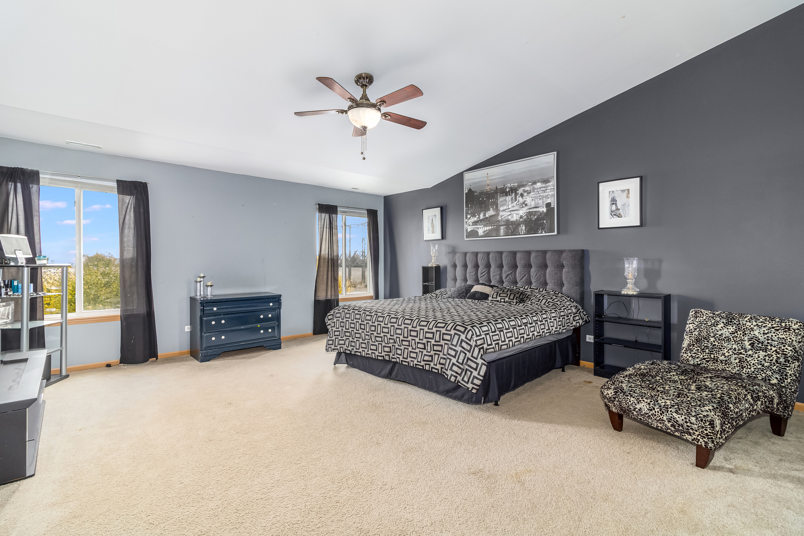 25801 South Red Oak Road Channahon, IL 60410 - Photo 14 of 24 a spacious bedroom with a bed and a chandelier