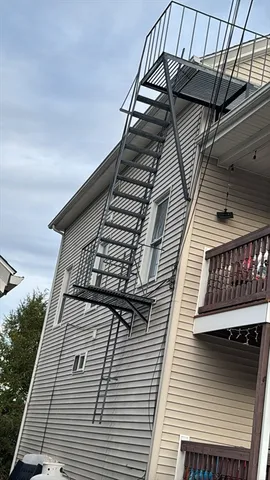 a front view of building with cars parked