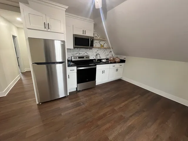 a white toilet sitting next to a white sink