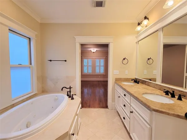 a bathroom with a granite countertop tub sink double vanity granite tub shower and mirror