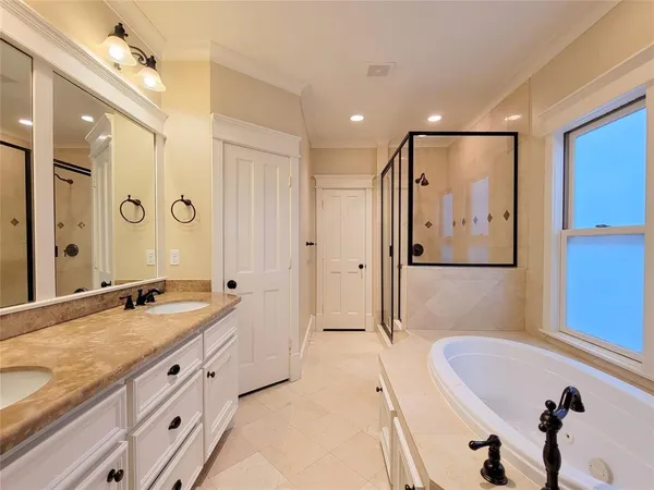 a spacious bathroom with a granite countertop tub sink shower and mirror