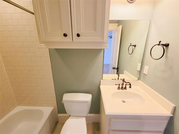 a bathroom with a sink toilet and tub