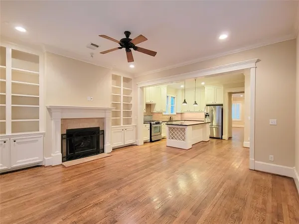 a view of a kitchen with a sink and a fireplace
