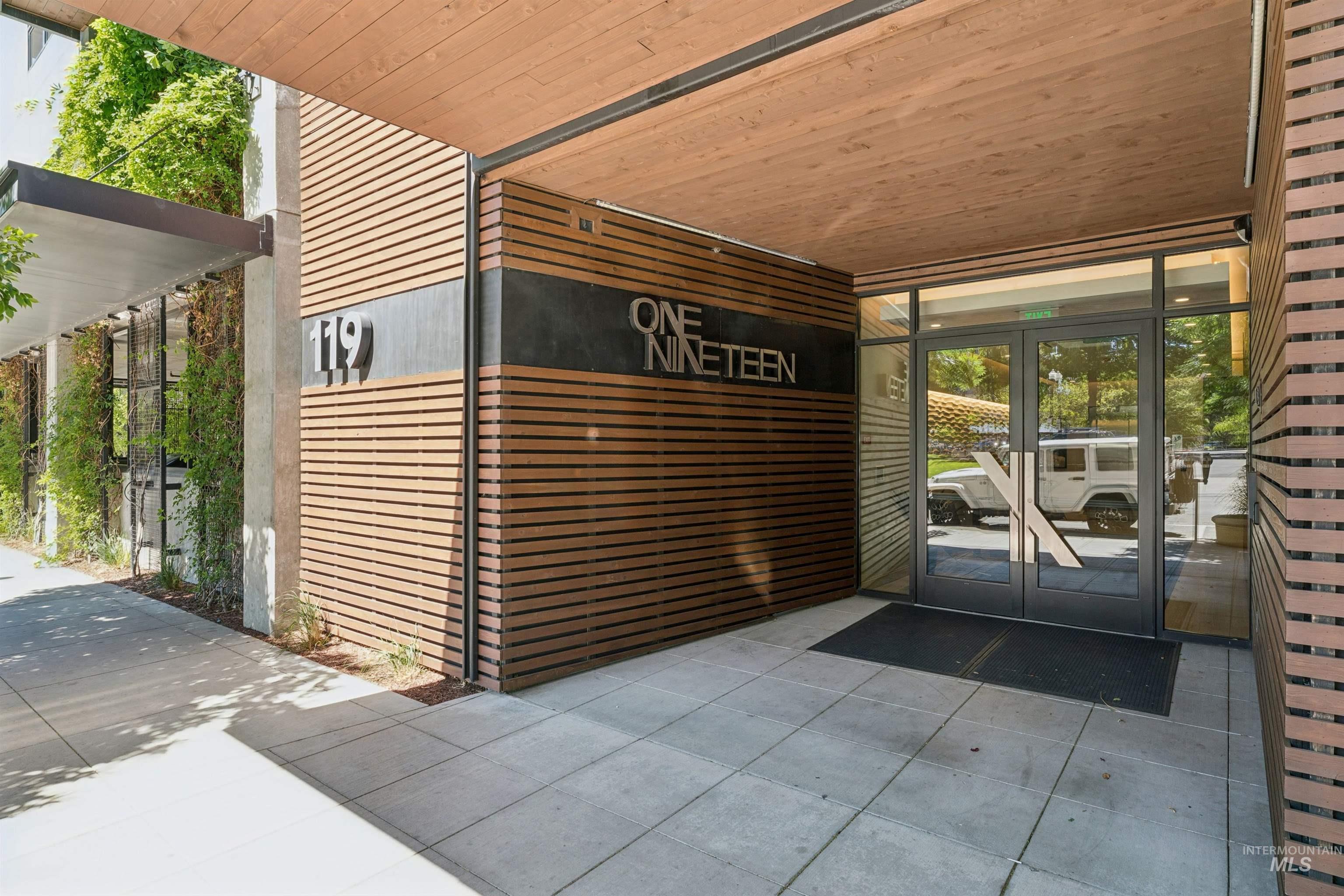 119 South 10th Street, Unit 307 Boise, ID 83702 - Photo 39 of 47 Building entrance featuring wood-slat siding, a wood-finish ceiling, and large glass double doors