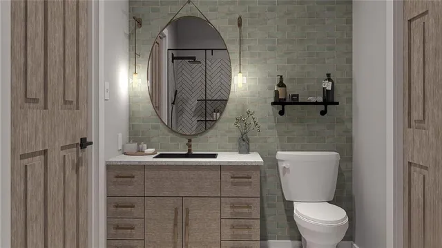 a bathroom with a toilet sink and mirror