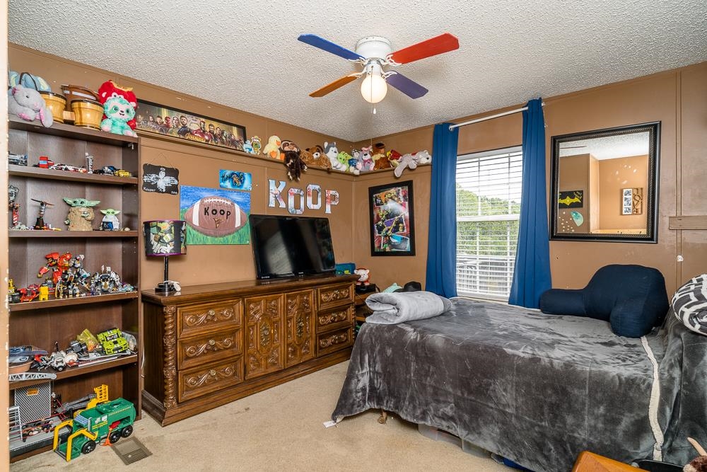 1271 Union Church Road Churchville, VA 24421 - Photo 12 of 46 a bedroom with a bed a dresser and a chandelier