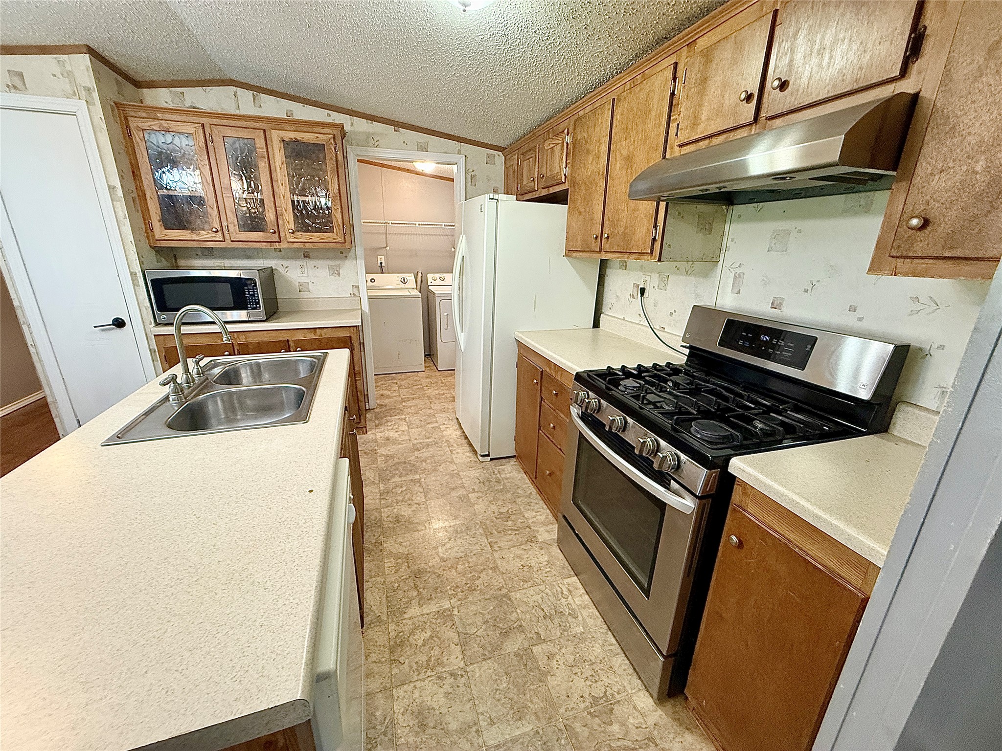 3075 FM 2001 Buda, TX 78610 - Photo 5 of 26 The kitchen offers ample counter space, full appliances, and access to the pantry.