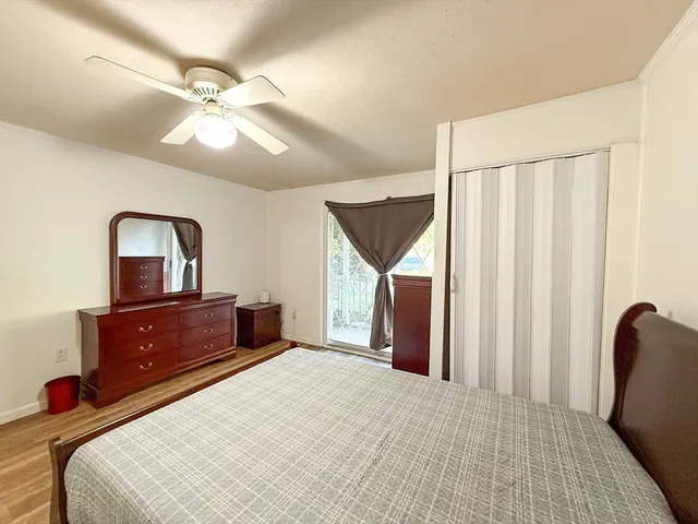 a bedroom with a bed dresser and a window