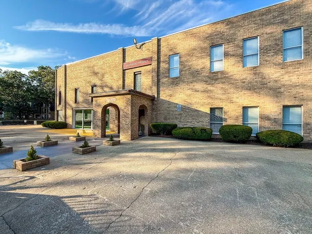a view of a building with sitting area