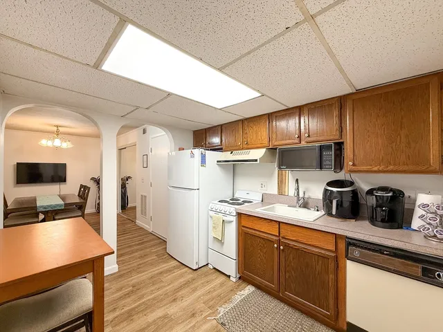 a kitchen with a sink stainless steel appliances cabinets and a counter top space
