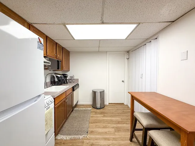 a kitchen with sink cabinets and wooden floor