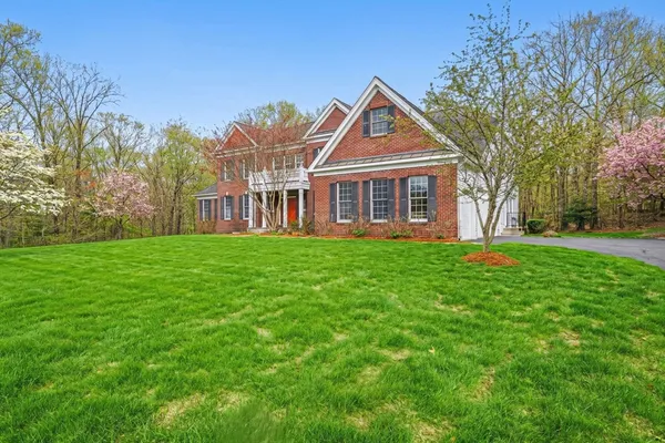 a front view of house with yard and green space