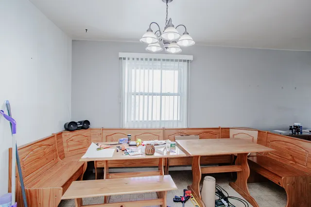 a bed room with a bed and a chandelier