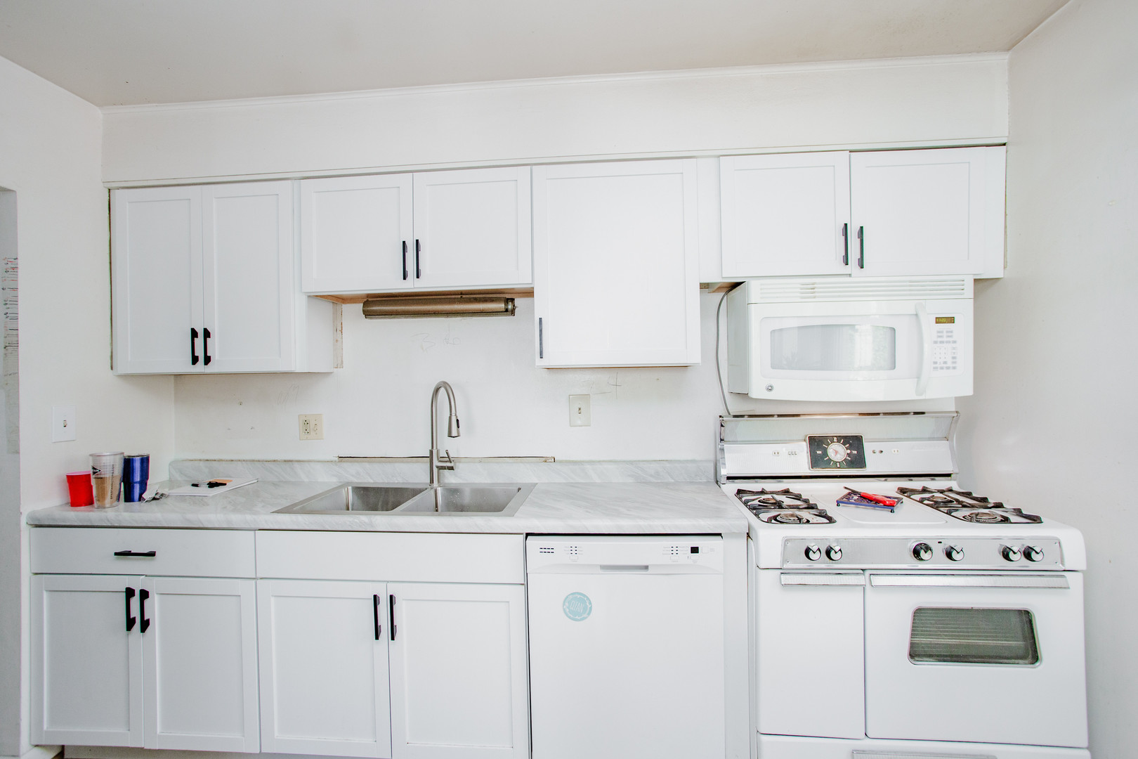 106 Woodcrest Circle Streamwood, IL 60107 - Photo 10 of 29 a kitchen with cabinets appliances a sink and a counter top space