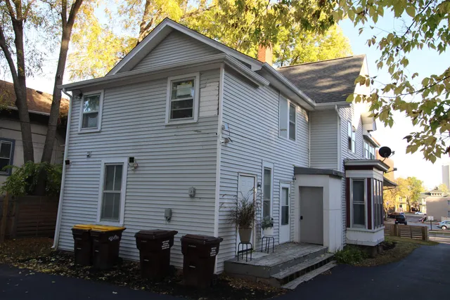 a front view of house with a garden and plants