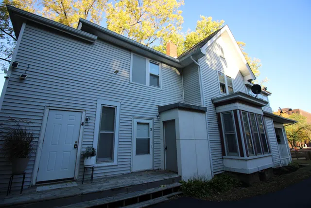 a view of a house with wooden fence